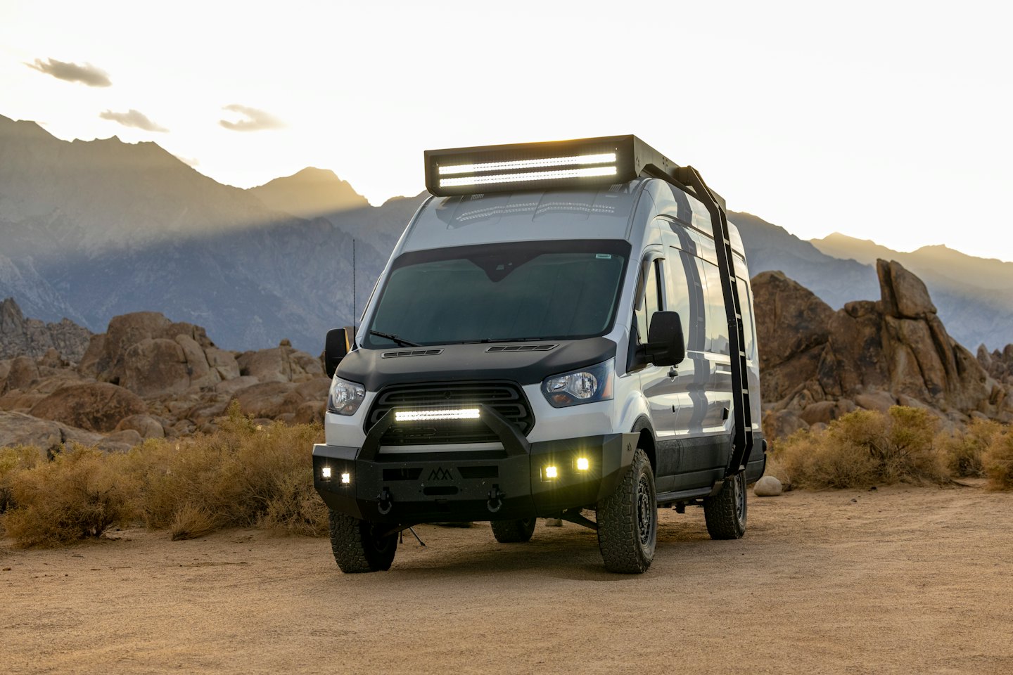 Customized camper van parked on a remote dirt road.